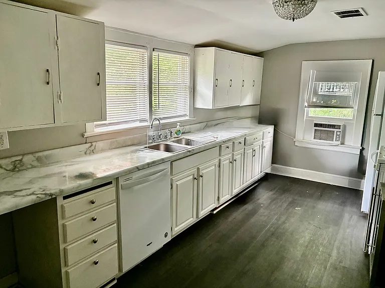 Kitchen w/ New Luxury Vinyl Tile! Kitchen w/ Designer Crystal Lighting. Appliances include NEW Refrigerator with ICEMAKER, Stove, Dishwasher and Wine Frig! Lots of Cabinets and Countertop Space! New Sherwin Williams French Gray Paint!