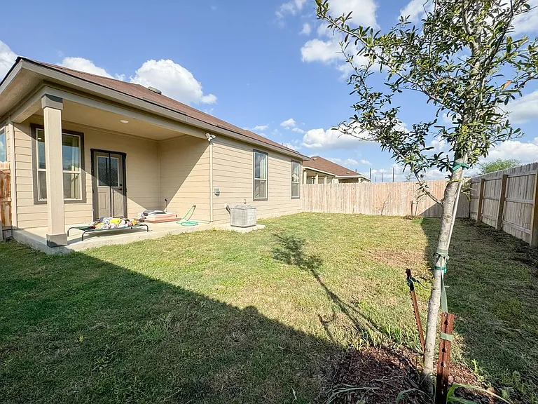 Fully fenced-in backyard with covered patio, perfect for pets!