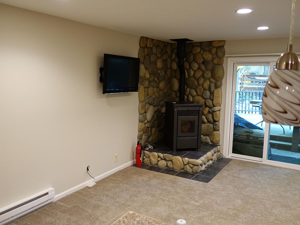 Wood burning pellet stove provides highly-efficient whole-home heating all winter long. (Electric baseboard is also available). Wall mount for your TV already in place in the living room!