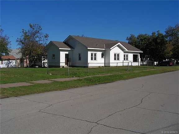 Back yard is partially fenced and has a driveway and pad for a possible garage.