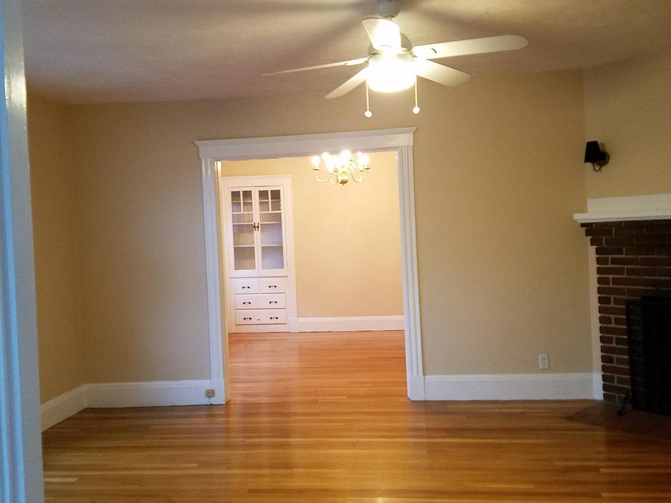 Living room and dining room (through arch) with large, built