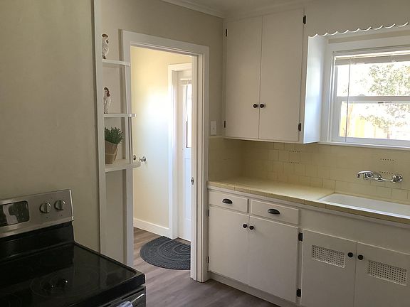 Kitchen with entrance to laundry room which leads to backyard.