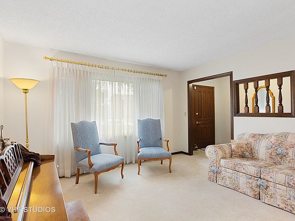 Enter in the foyer with a coat closet then into the living room with good light and lots of wall spa