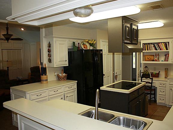 Huge upgraded kitchen w/ Island cook top, double ovens, breakfast bar. Extensive cabinetry & counter space, plus built-in desk and shelving!