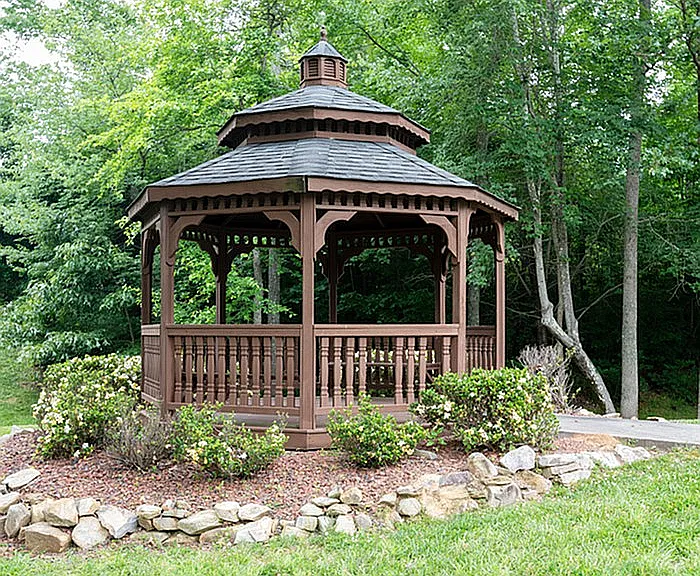 Embrace tranquility with this charming wooden gazebo, perfect for relaxing amidst nature.