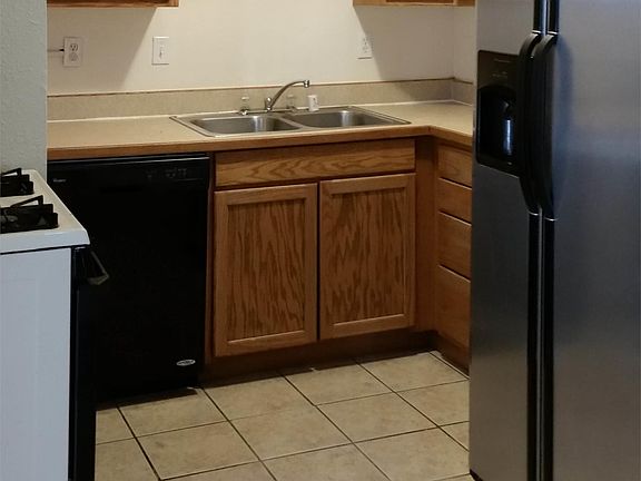 Kitchen - gas range, side-by-side refrigerator and newer dis