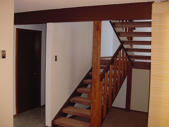 Stairs to bedrooms with storage underneath
