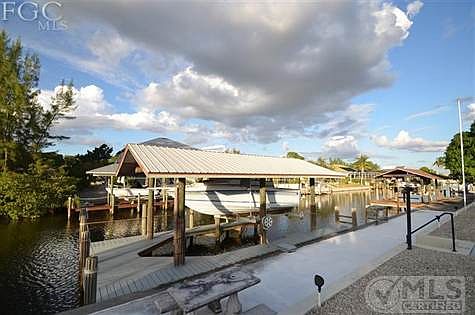 Covered Boat Lift with wrap around boat dock.