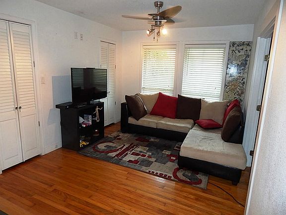 Living room opens to kitchen. French doors on right lead to