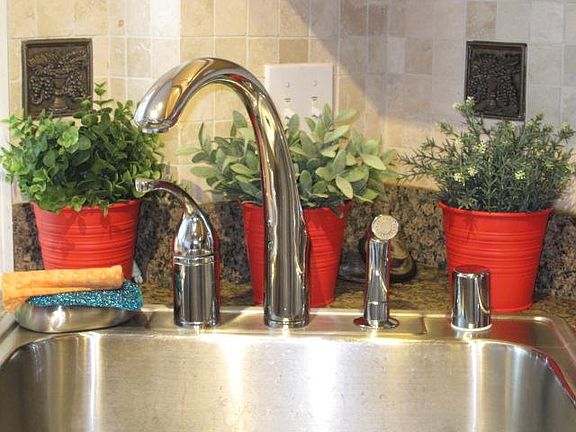 Kitchen sink overlooks fenced backyard