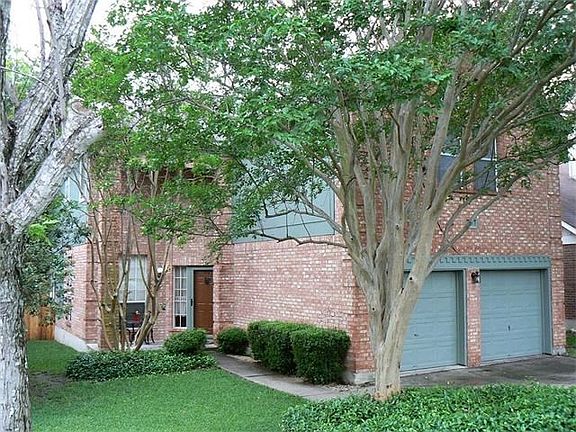 Front yard with very nice landscaping and Large shade trees that shade the entire home.