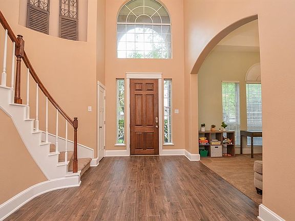 Beautiful front entry with high arched windows and side lights.
