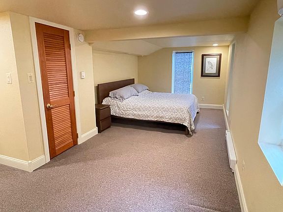 Large bedroom with King bed, 2 nightstands, dresser, walk-in closet, 3 large windows; Linens provided