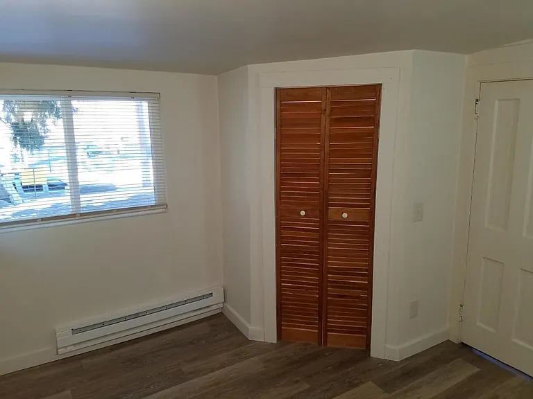 Bedroom closet, there are two windows all new flooring and baseboard heater.