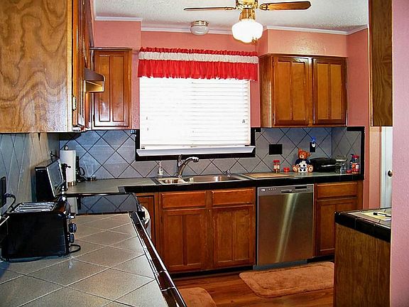 Tile counter tops compliment the black & stainless appliances!