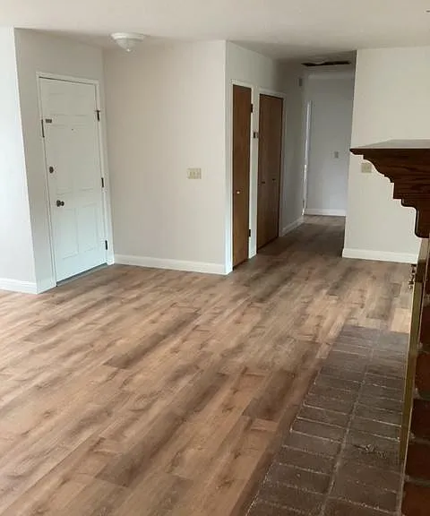 Looking from the TV room doorway to the front door and hallway to bedrooms