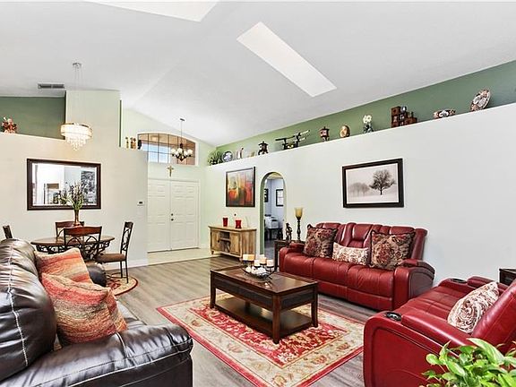 Spacious formal living room, dining room looking to the double door entry. Plenty of natural light with 2 skylights.