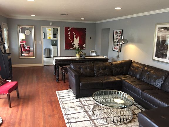 Recessed lighting reflects off the hardwood flooring