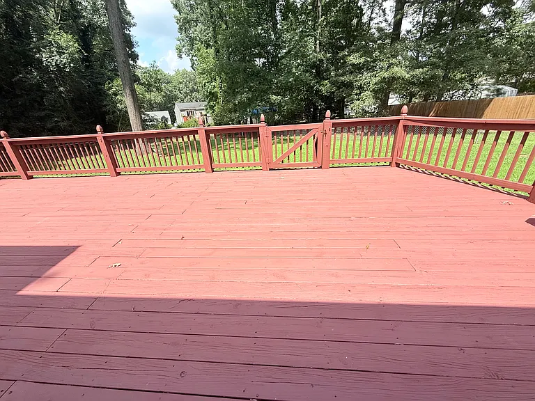 Massive, newly stained rear deck accessed through the 2 car garage