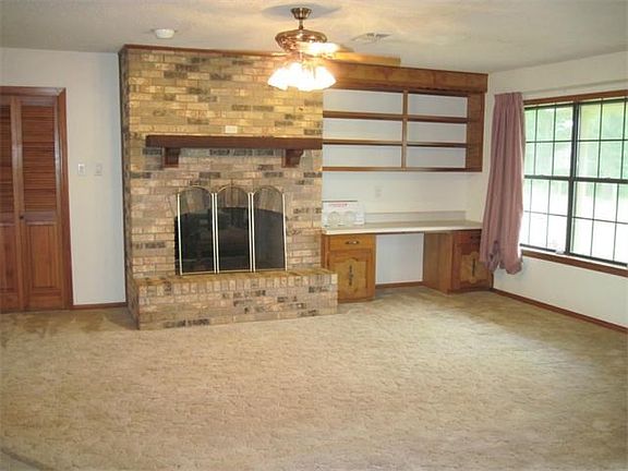 Very nice family/living area with a see-thru fireplace and a built-in desk and ceiling fan.  Lots of light from the big windows.