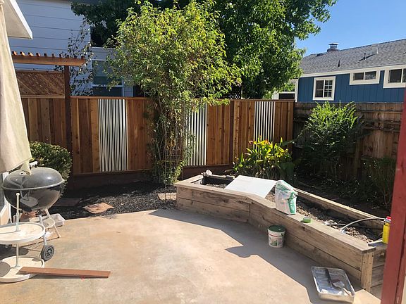 Back patio and current construction zone- planter box left open for your flowers or veggies. Hedges just planted along back fence to block view of the blue house.