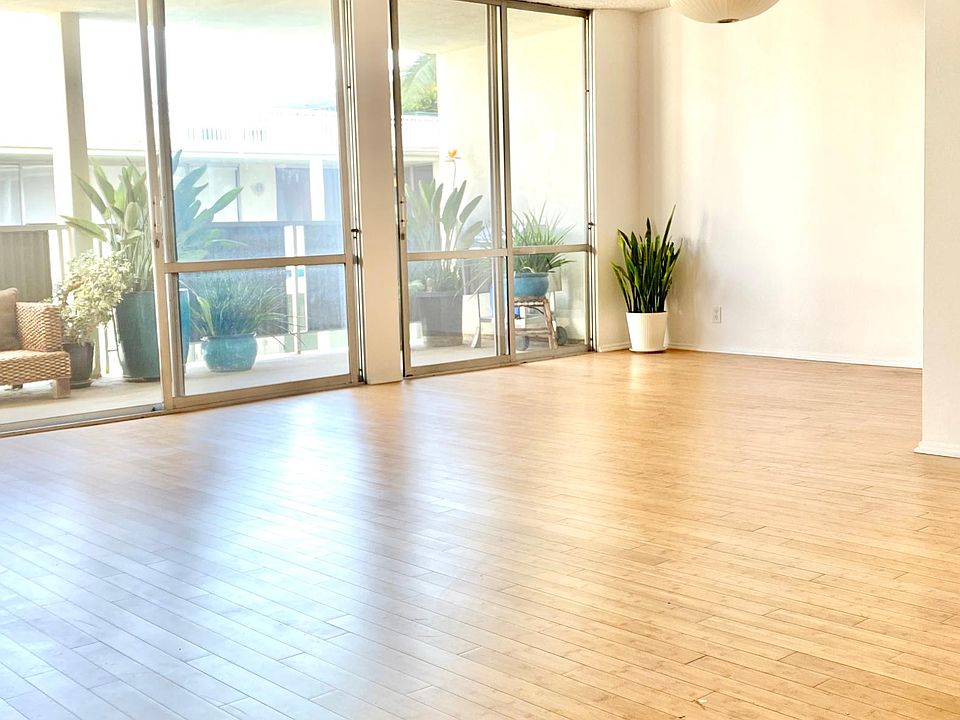OPEN CONCEPT LIVING ROOM/DINING. ENTIRE WALL IS SLIDING GLASS DOORS, VERY PRETTY AND BRIGHT.