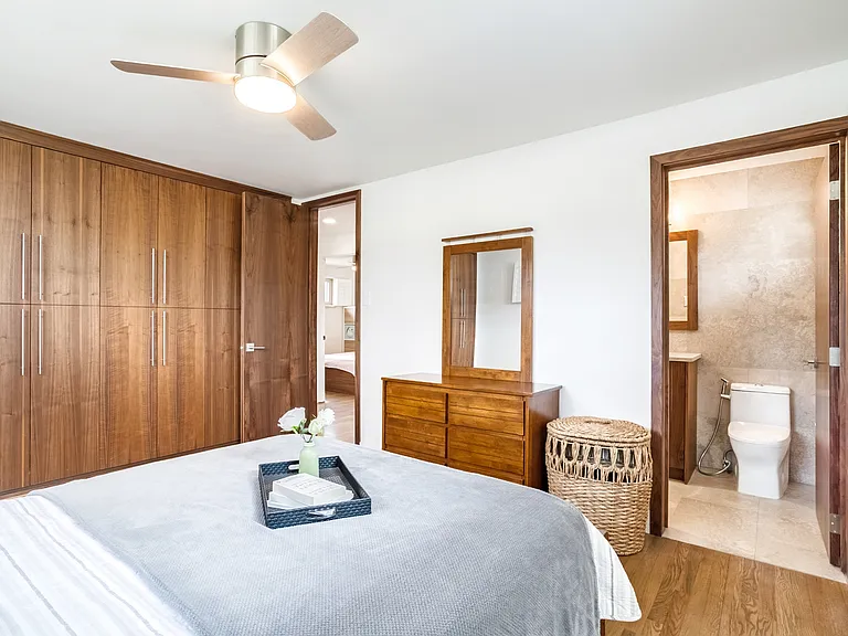 Custom built walnut closets with attached full bathroom.