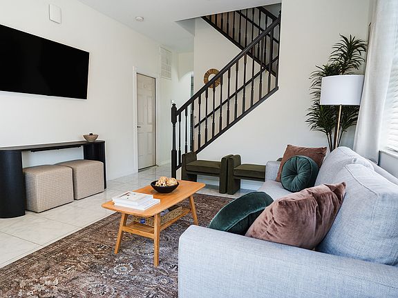Main entrance leads to a spacious and bright living room with high ceilings.