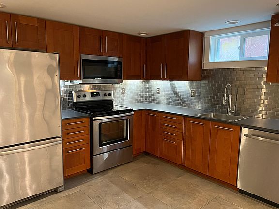 Newly remodeled kitchen with stainless fridge, oven, microwave and dishwasher.