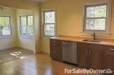Brand new kitchen and sunroom
						:
						This sunny eat-in kitchen looks out onto the back yard.