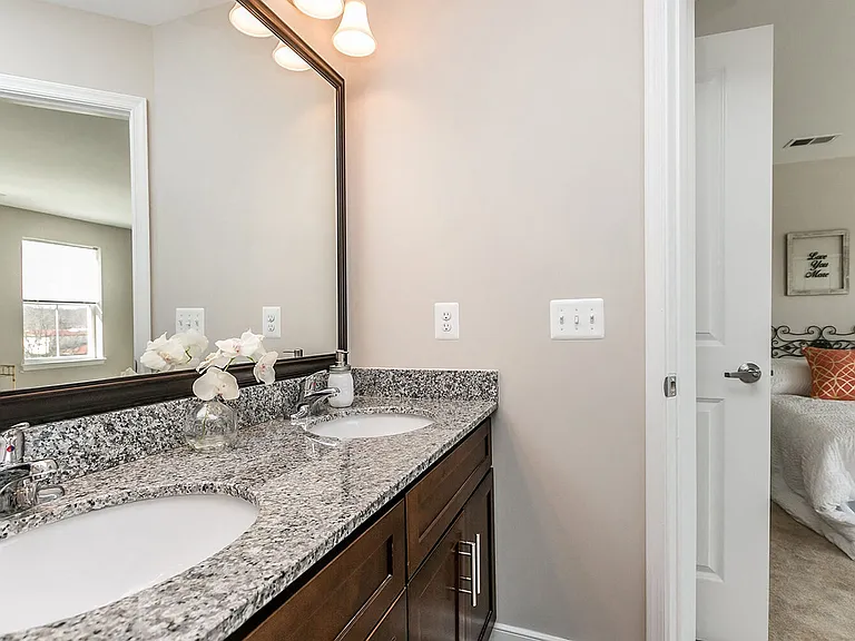 Spa-inspired bathrooms with solid-wood cabinetry, double-vanity and granite countertops