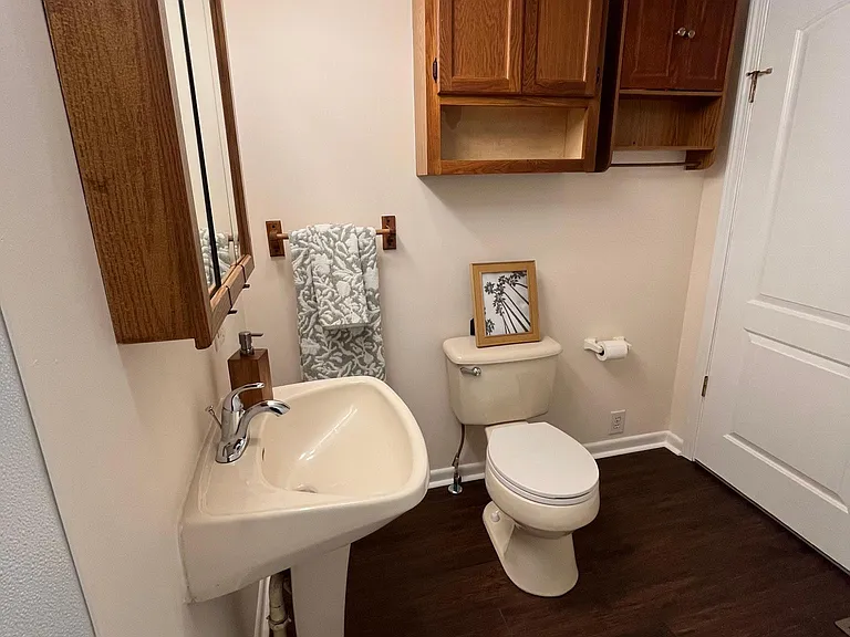 Second full bathroom with three storage cabinets. Triple mirror vanity so you can see different angles of your hair-do!
