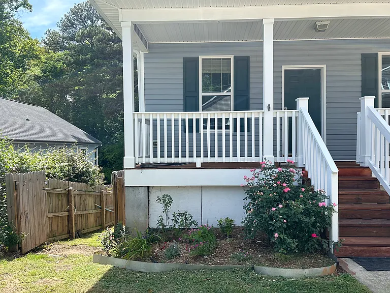 To the left of the house is the second entrance to the backyard, where your private outdoor space begins.
