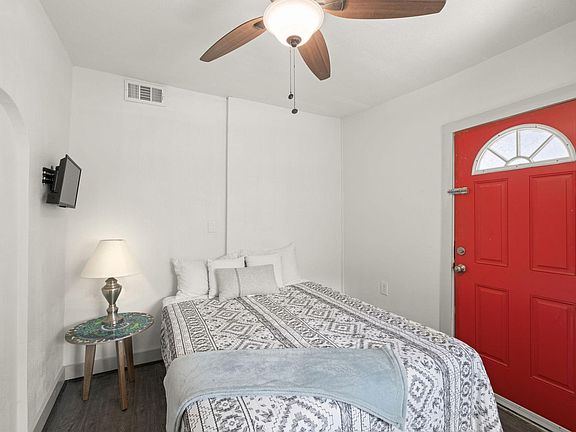 This bedroom has a red exterior door.