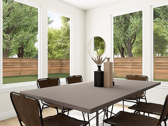 A modern dining room with a rectangular table and chairs, surrounded by large windows overlooking a