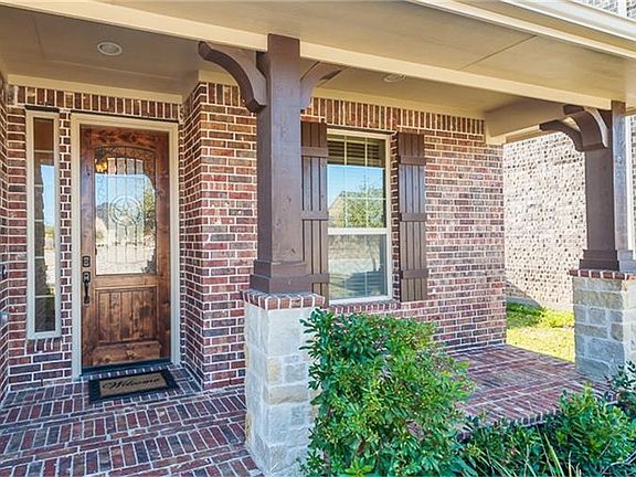 This charming Texas Hill Country front porch features cedar style beams, columns and shutters and Al