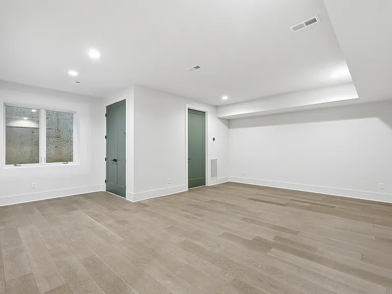 Spacious primary suite with recessed lighting, modern finishes, and plenty of room to relax.