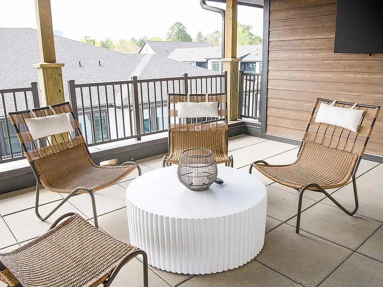Cozy balcony with wicker style chairs and large flatscreen television