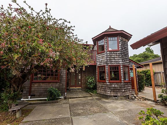 Patio off second bedroom, first floor, left side. Kitchen to right. Turret above, right. Balcony second floor off Master bedroom and off Turret room.