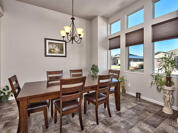 The spacious formal dining room is richly finished in oversized tile, and a tall