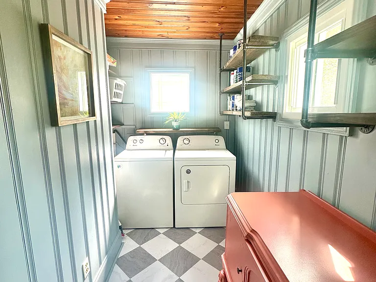Laundry room with washer and dryer. Plentiful storage
