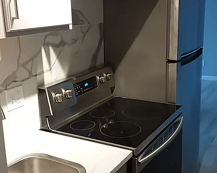 Full sized stainless steel stove with convection features and refrigerator with high end finishes.