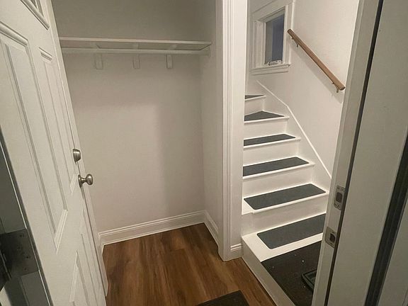 First floor entry way and coat closet with new vinyl planking flooring and stair treads and recently painted.