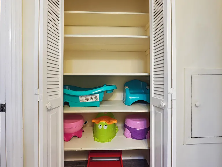 Kids potties, baby bath and step-stool in Upstairs Hallway Bathroom closet