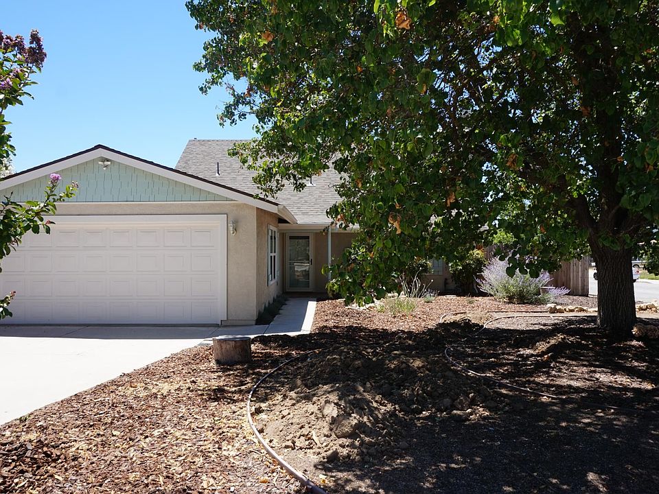 Front yard with mature tree. Parking available on driveway. Garage is not available to tenant.