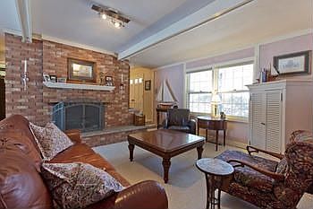A wonderful family room with a brick fireplace.