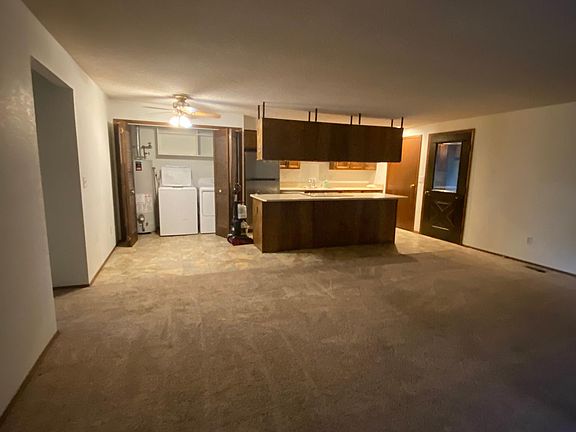 Open living room, kitchen & washer/dryer area.