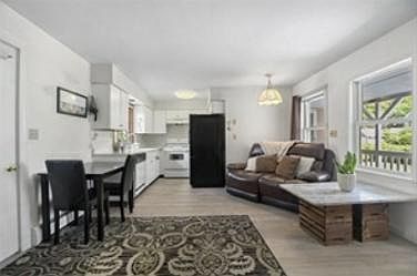 Open perfect flow space - Powder room, living area, dining, and then kitchen at the side. The other side has stairs to go upstairs to the Bedroom#2 with attached bathroom
