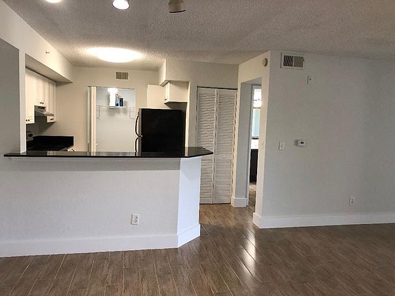 Kitchen w/washer and dryer in the back closet and a pantry closet next to the refrigerator