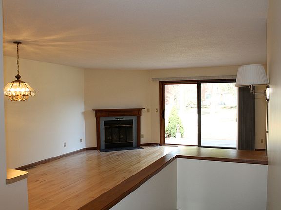 Large sliding doors open to a deck and common area behind home.